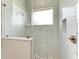 Walk-in shower with marble tile and glass enclosure at 901 30Th E Ct, Bradenton, FL 34208