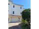 Inviting three-story townhome with a charming Spanish-style roof and lush landscaping at 9923 Manatee W Ave # 4, Bradenton, FL 34209