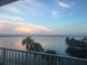 Stunning water view from private balcony, showcasing serene sunset over calm waters at 9923 Manatee W Ave # 4, Bradenton, FL 34209