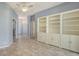 Living room with built-in shelving and tile floors at 10643 Old Grove Cir, Bradenton, FL 34212