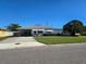 Ranch-style home with carport and yard at 1205 Harvard Ave, Bradenton, FL 34207