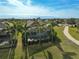 Elevated view of a home's screened pool and patio area with surrounding landscaping and neighboring houses at 12180 Longview Lake Cir, Bradenton, FL 34211