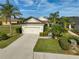 Aerial view of a single-Gathering home with a two-car garage and lush landscaping at 12180 Longview Lake Cir, Bradenton, FL 34211