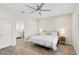 Spacious main bedroom with ensuite bathroom, ceiling fan, and wood floors at 12180 Longview Lake Cir, Bradenton, FL 34211