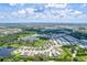 Aerial view of a large Florida community featuring many houses and lakes at 12939 Seasong Ter, Bradenton, FL 34211