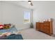 Bright bedroom with large window, plush carpet, and wood dresser at 12939 Seasong Ter, Bradenton, FL 34211
