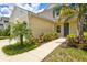 Front door entrance with walkway and lush landscaping at 12939 Seasong Ter, Bradenton, FL 34211