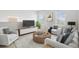 Spacious living room with contemporary furnishings and large windows at 12939 Seasong Ter, Bradenton, FL 34211