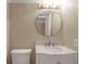 Simple bathroom with white vanity, marble countertop and round mirror at 1460 Landings Cir # 51, Sarasota, FL 34231