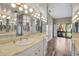 Bathroom with double vanity and shower, mirrored walls at 1460 Landings Cir # 51, Sarasota, FL 34231