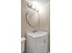 Clean bathroom with a white vanity, marble countertop and round mirror at 1460 Landings Cir # 51, Sarasota, FL 34231