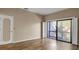 Bright bedroom with wood floors and sliding glass doors leading to a private balcony at 1460 Landings Cir # 51, Sarasota, FL 34231