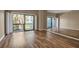 Spacious bedroom featuring wood-look floors and a mirrored wall at 1460 Landings Cir # 51, Sarasota, FL 34231
