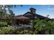 Community building with covered patio and lush landscaping at 1460 Landings Cir # 51, Sarasota, FL 34231