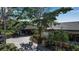 Landscaped community entrance with paved driveway and mature trees at 1460 Landings Cir # 51, Sarasota, FL 34231