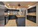Spacious kitchen with island, stainless steel appliances, and dark cabinets at 1460 Landings Cir # 51, Sarasota, FL 34231