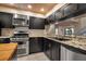 Modern kitchen with stainless steel appliances and dark cabinetry at 1460 Landings Cir # 51, Sarasota, FL 34231
