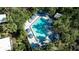 Community pool with striped umbrellas and plenty of lounge chairs at 1460 Landings Cir # 51, Sarasota, FL 34231