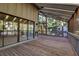 Outdoor screened porch with wooden deck and surrounding trees at 1460 Landings Cir # 51, Sarasota, FL 34231