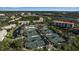 Aerial view of community tennis courts near the pool and residential buildings at 1460 Landings Cir # 51, Sarasota, FL 34231