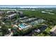 Community tennis courts and pool with lush landscaping and residential buildings nearby at 1460 Landings Cir # 51, Sarasota, FL 34231