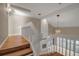 Upstairs hallway with wood flooring and views to the lower level at 1460 Landings Cir # 51, Sarasota, FL 34231