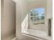 Bathroom featuring a large soaking tub, shower, and window with natural light at 21709 Deer Pointe Xing, Bradenton, FL 34202