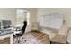 Bright home office features wood floors, comfortable seating, and a large window at 21709 Deer Pointe Xing, Bradenton, FL 34202