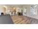 Open floor plan with kitchen, dining area, and access to backyard patio at 21709 Deer Pointe Xing, Bradenton, FL 34202