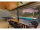Relaxing pool area with covered patio, outdoor dining, and ping pong table at 21709 Deer Pointe Xing, Bradenton, FL 34202