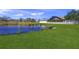 Large backyard with pond view and white fence at 2419 7Th E Ct, Ellenton, FL 34222