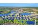 Aerial view of homes near a lake at 249 Palmaria Ct, Nokomis, FL 34275