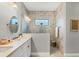 Stylish bathroom features a double vanity, sleek fixtures, and a walk-in shower with marble tile surround at 249 Palmaria Ct, Nokomis, FL 34275