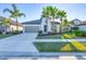 Front view of a one-story house with palm trees and a two-car garage at 249 Palmaria Ct, Nokomis, FL 34275