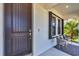 Modern front door with sidelight window, offering curb appeal and security at 249 Palmaria Ct, Nokomis, FL 34275
