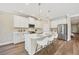 Bright and modern kitchen featuring stainless steel appliances and large island with bar stool seating at 249 Palmaria Ct, Nokomis, FL 34275