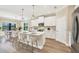 Bright kitchen featuring stainless steel appliances, a large island with bar stool seating, and an adjacent dining area at 249 Palmaria Ct, Nokomis, FL 34275