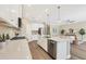 Bright kitchen featuring stainless steel appliances, a large island, and open layout to the living area at 249 Palmaria Ct, Nokomis, FL 34275