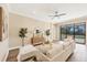 Bright living room features sliding glass doors, modern decor, and pool views at 249 Palmaria Ct, Nokomis, FL 34275