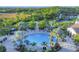 Overhead view of the large community pool with lounge chairs, tables, and beautiful landscaping at 249 Palmaria Ct, Nokomis, FL 34275