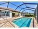 A screened pool and brick patio area with a glimpse of the home's exterior at 249 Palmaria Ct, Nokomis, FL 34275