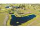 Aerial view of a house, pond and land, showcasing the expansive land ideal for building or recreation at 25205 67Th E Ave, Myakka City, FL 34251
