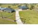 Aerial view of house and outbuildings, a long driveway and open space for outdoor activities and storage at 25205 67Th E Ave, Myakka City, FL 34251