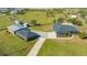 Aerial view of home, detached garage, and open space, perfect for outdoor enthusiasts and storage at 25205 67Th E Ave, Myakka City, FL 34251