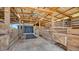 Spacious horse barn featuring wooden stalls, overhead lighting and fans, providing a comfortable environment at 25205 67Th E Ave, Myakka City, FL 34251