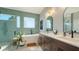 Bathroom features double sink vanity, soaking tub, glass enclosed shower, and tile floors at 25205 67Th E Ave, Myakka City, FL 34251
