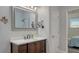Bathroom featuring a dark wood vanity with a white countertop and a walk-in shower at 25205 67Th E Ave, Myakka City, FL 34251