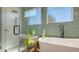 Bathroom features soaking tub, glass enclosed shower with rainfall shower head and tile floors at 25205 67Th E Ave, Myakka City, FL 34251