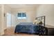Simple bedroom with blue bedding, dresser, and view of the outdoor canopy at 25205 67Th E Ave, Myakka City, FL 34251