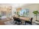 Bright dining room features a wooden table with seating for six and a decorative light fixture at 25205 67Th E Ave, Myakka City, FL 34251